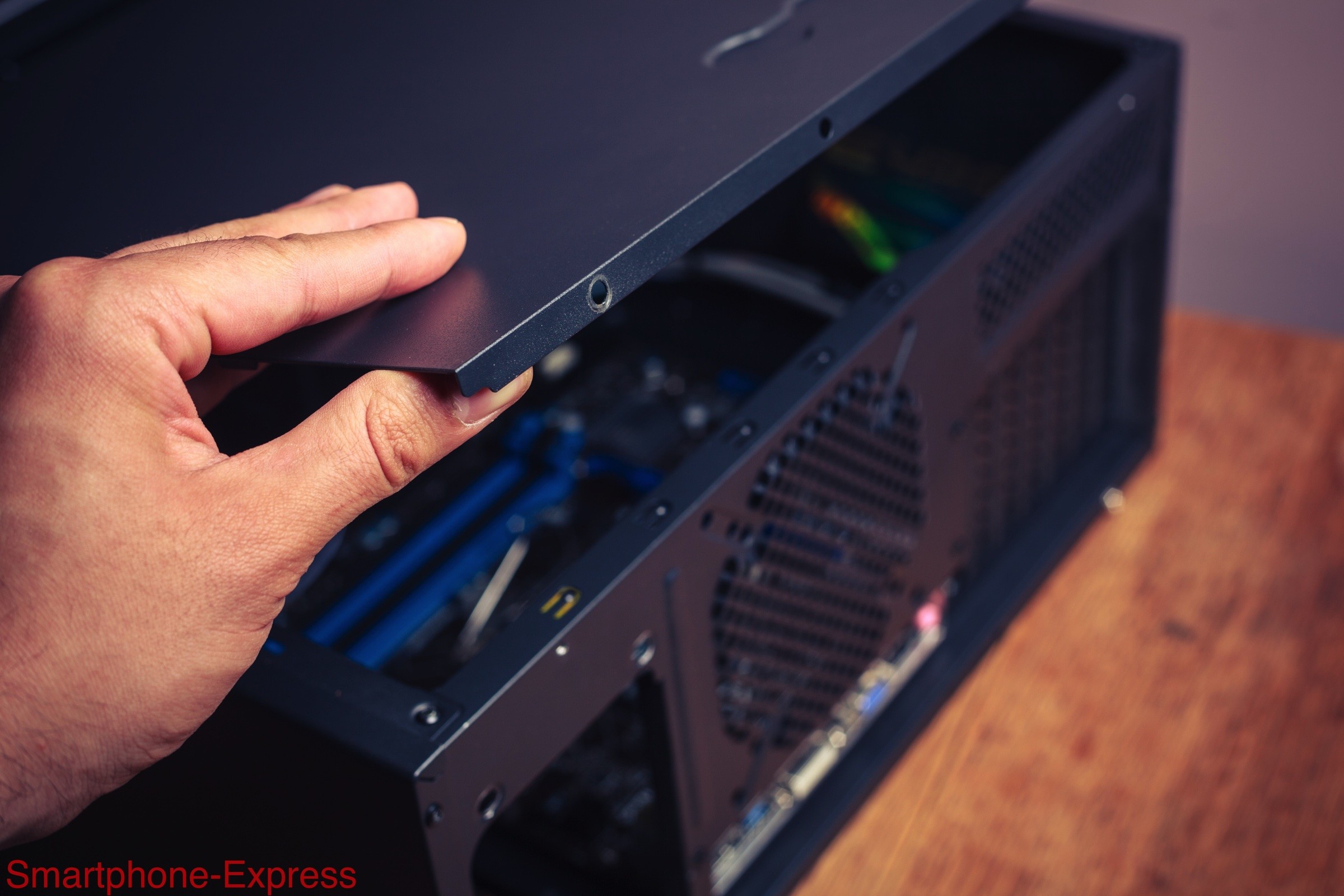 Hand opening a computer case